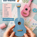 Guitare en carton faite maison, montrant créativité et recyclage.
